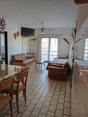a living room with a bed and a couch at Casa Lago Azul in Villa Santa Cruz del Lago
