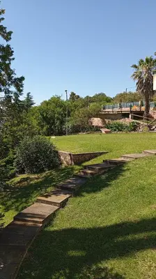 a set of stone steps in a grass field at Casa Lago Azul in Villa Santa Cruz del Lago