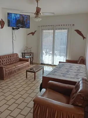 a bedroom with a bed and a couch and a tv at Casa Lago Azul in Villa Santa Cruz del Lago