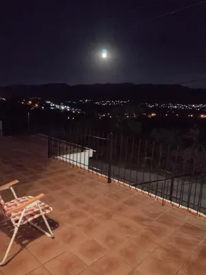 a chair sitting on top of a patio at night at Hermosa Casa para 6 personas en Parque Siquiiman Cordoba in Villa Parque Siquiman