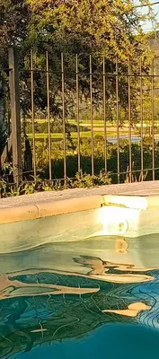 a reflection of a woman in a pool of water at Hermosa Casa para 6 personas en Parque Siquiiman Cordoba in Villa Parque Siquiman