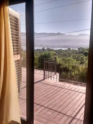 a view from a glass door of a balcony with a view at Hermosa Casa para 6 personas en Parque Siquiiman Cordoba in Villa Parque Siquiman