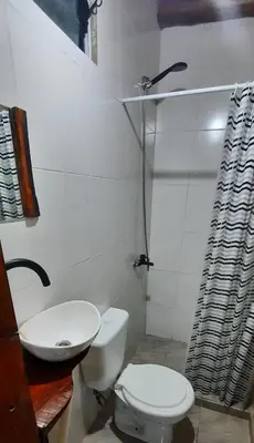 a bathroom with a toilet and a sink at Cabaña Paz in Santa Rosa de Calamuchita