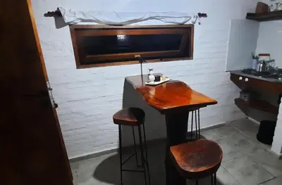 a bar in a room with two stools and a sink at Cabaña Paz in Santa Rosa de Calamuchita