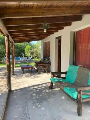 an outdoor patio with a couch and a table at Cabañas Doña Chicha - San Clemente, Córdoba in San Clemente
