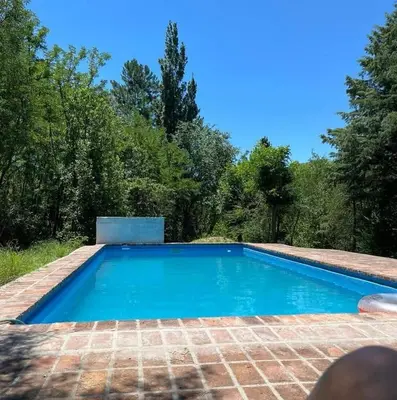 a swimming pool in the middle of a yard at Cabañas Doña Chicha - San Clemente, Córdoba in San Clemente