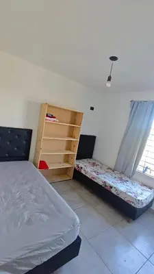 a bedroom with two beds and a window at Cabaña la Fride in Cosquín