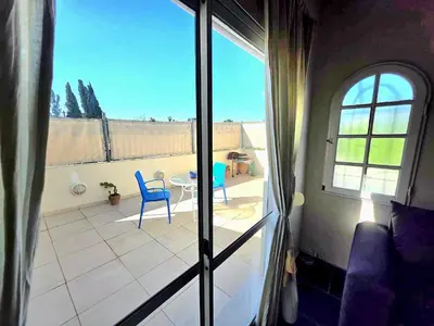 a view of a balcony with two chairs and a table at Mona Suites in Cordoba