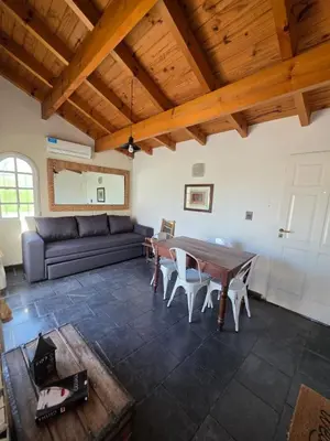 a living room with a couch and a table at Mona Suites in Cordoba