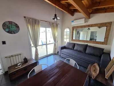 a living room with a couch and a table at Mona Suites in Cordoba