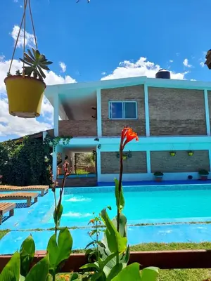 a house with a swimming pool in front of it at Departamentos Las Marias in Villa Cura Brochero