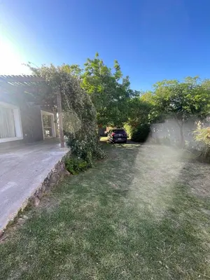 a yard with a car parked next to a house at Mi casita en Embalse in Embalse