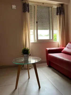 a living room with a red couch and a glass table at Portal de la Cañada in Cordoba
