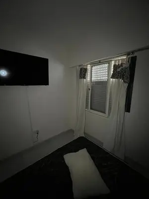 a room with a bed and a television and a window at Portal de la Cañada in Cordoba