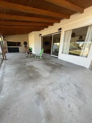 a large patio with chairs in a house at Los viejos Potrero de Garay in Villa Anizacate