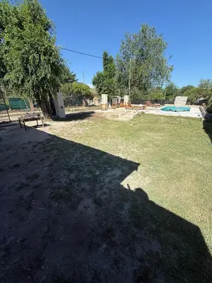 a large yard with a bench in the grass at Los viejos Potrero de Garay in Villa Anizacate
