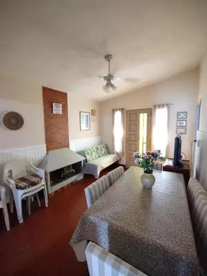 a living room with a table and a couch at Casa en VCP a la vuelta de la Costanera in Villa Carlos Paz