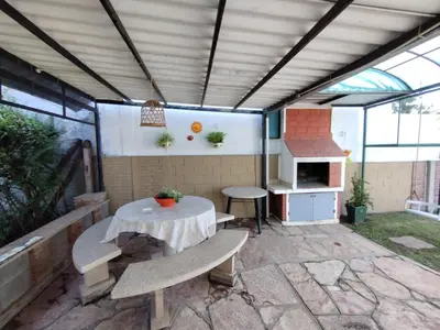 a patio with a table and a stove at Casa en VCP a la vuelta de la Costanera in Villa Carlos Paz