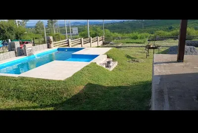 a swimming pool in a yard with a grassy field at Rincon de Bialet in Bialet Massé