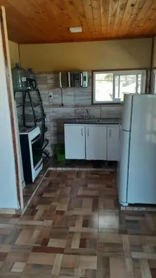 a kitchen with white appliances and a wooden ceiling at Rincon de Bialet in Bialet Massé