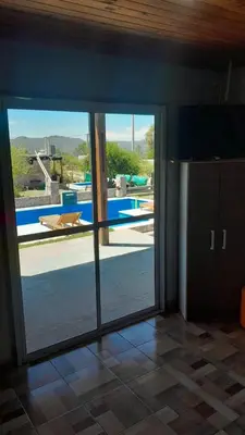 a room with a sliding glass door leading to a pool at Rincon de Bialet in Bialet Massé