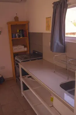 a kitchen with a counter top and a sink at Ikigai alojamiento con piscina in Villa Rumipal