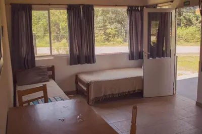 a small bedroom with a bed and a window at Ikigai alojamiento con piscina in Villa Rumipal