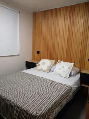 a bedroom with a bed with two pillows on it at Cabaña Villa Alpina in Tanti