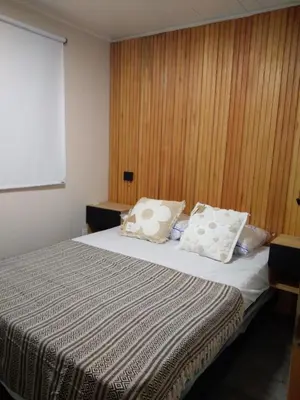 a bedroom with a bed with two pillows on it at Cabaña Villa Alpina in Tanti