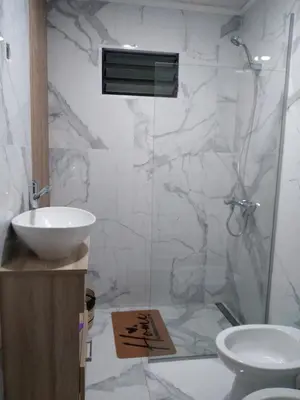 a bathroom with a toilet and a sink and a shower at Cabaña Villa Alpina in Tanti