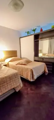 a hotel room with two beds and a mirror at El Valtodano in Cordoba