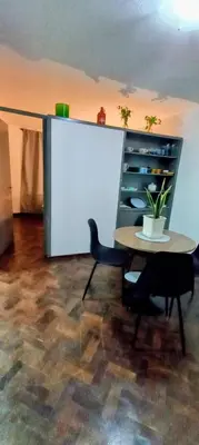 a table with two chairs and a potted plant on it at El Valtodano in Cordoba