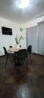 a table with chairs and a plant in a room at El Valtodano in Cordoba