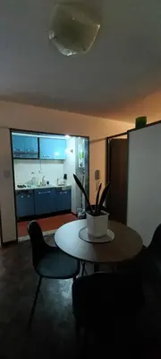 a living room with a table and chairs and a kitchen at El Valtodano in Cordoba