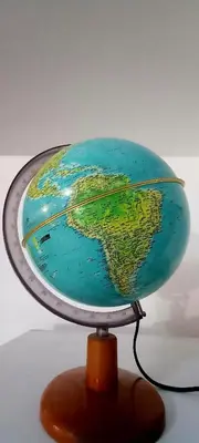 a glass globe of the world on a wooden stand at El Valtodano in Cordoba