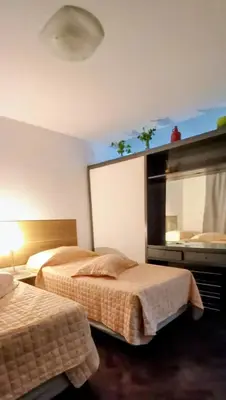 a hotel room with two beds and a mirror at El Valtodano in Cordoba
