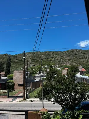 a view of a city with a mountain in the background at Departamento Santa rita in Villa Carlos Paz