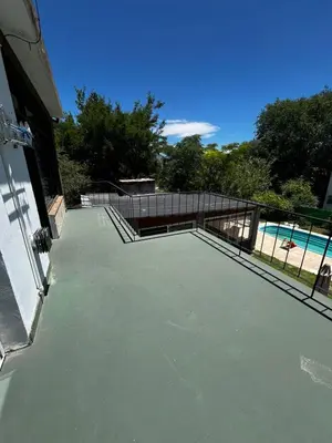 a patio with a fence and a swimming pool at Departamento Santa rita in Villa Carlos Paz