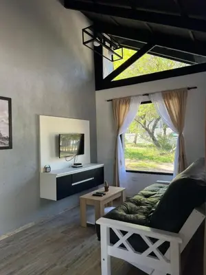 a living room with a couch and a window at Altos de Lagunitas in Villa General Belgrano