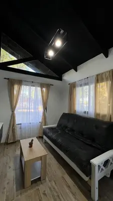 a living room with a black couch and a table at Altos de Lagunitas in Villa General Belgrano
