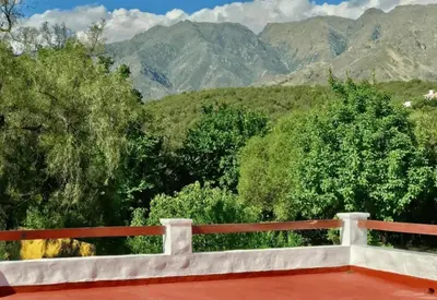 a balcony with a view of mountains and trees at Hosteria de los Césares in Merlo