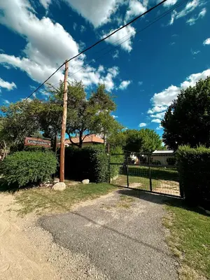 a telephone pole in a yard with a fence at La Herradura in Mina Clavero