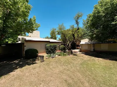 a yard in front of a house with trees at La Herradura in Mina Clavero