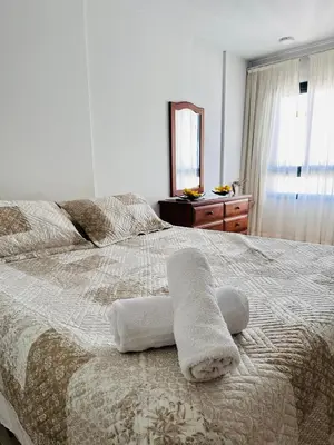 a bedroom with a bed with two towels on it at Departamento premium con balcón, vista y atardeceres in Cordoba