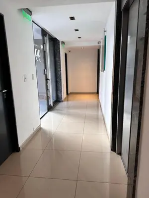 a corridor of an office building with a long hallway at Departamento premium con balcón, vista y atardeceres in Cordoba