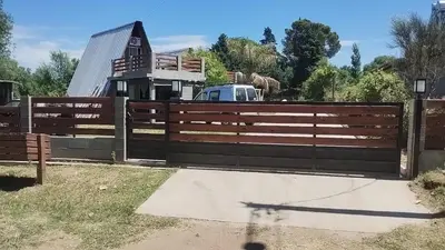 a wooden fence in front of a house at Altos del torreón in Villa Rumipal