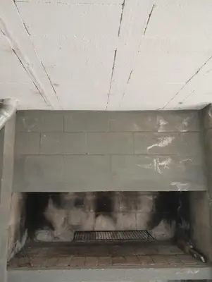a fireplace in a room with a brick wall at Altos del torreón in Villa Rumipal