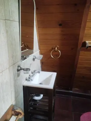a bathroom with a sink and a mirror at Altos del torreón in Villa Rumipal