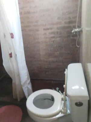 a small bathroom with a toilet and a shower at Altos del torreón in Villa Rumipal