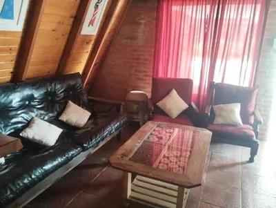 a living room with a leather couch and two chairs at Altos del torreón in Villa Rumipal